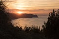 Sunset with orange sky near the hermitage of San Juan de Gaztelugatxe located on an islet in Bermeo, Vizcaya