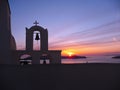 Sunset through the Orthodox church bell tower on Santorini Royalty Free Stock Photo