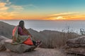 Girl Wrapped in Blanket while watching sunset Royalty Free Stock Photo