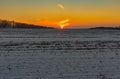 Sunset over agricultural field at winter season Royalty Free Stock Photo