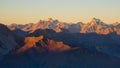 Sunset over the Alps. Colorful sky, high altitude mountain peaks with glaciers, Massif des Ecrins National Park, France. Telephoto