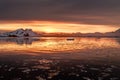 Sunset over antarctic lagoon with drifting icebergs and snow peaks in the background, Lemaire Channel