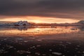 Sunset over antarctic lagoon with drifting icebergs and snow peaks in the background, Lemaire Channel