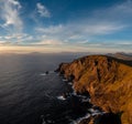 Sunset over the Atlantic Ocean and the cliffs of Bray Head on Valentia Island in County Kerry Royalty Free Stock Photo
