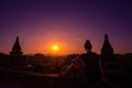 Tourist in Burma Woman admires beautiful Sunset over Pagodas in the City of Bagan Myanmar Royalty Free Stock Photo