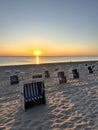 Sunset over the Baltic Sea beach with Strandkorb lounge chairs in Westerland, Sylt, Schleswig-Holstein, Germany, June 2023