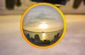 Sunset over baltic sea and coast of Swinoujscie city seen from breakwater in glassball Royalty Free Stock Photo