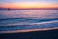 Sunset over bay with Delaware Breakwater Lighthouse in distance Royalty Free Stock Photo