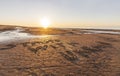 Sunset over the beach on the Baltic sea coast. Words in support of Ukraine are written on sand