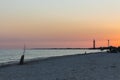 Sunset over beach with silhouettes of lighthouse and fishing equipment. Colorful evening sky in dusk on the island. Coastal nature Royalty Free Stock Photo