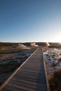 Sunset over boardwalk at the Old Faithful geyser basin in Yellowstone National Park in Wyoming USA Royalty Free Stock Photo