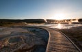 Sunset over boardwalk at the Old Faithful geyser basin in Yellowstone National Park in Wyoming USA Royalty Free Stock Photo