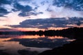 A sunset over a body of water with a mountain in the background Royalty Free Stock Photo