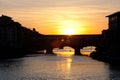 Sunset over bridges through the river Arno