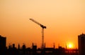 Sunset over Building construction in the city. Crane and structure silhouettes Royalty Free Stock Photo