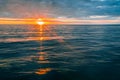 Sunset over calm ocean water. Royalty Free Stock Photo