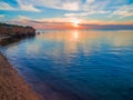 Sunset over calm ocean water. Royalty Free Stock Photo