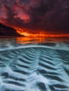 Sunset over calm sea with underwater sand patterns, captured in a split view seascape Royalty Free Stock Photo