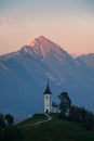 Sunset over The Church of St. Primoz and Felicijan in the village of Jamnik. The last ray of sun on the Alps in Slovenia. Vertical Royalty Free Stock Photo
