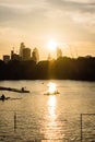 Sunset over the city of London with rowers in the foreground Royalty Free Stock Photo