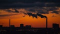 Sunset over a city with smoking chimneys Royalty Free Stock Photo