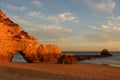 Sunset over cliffs at deserted beach in Algarve, Portugal Royalty Free Stock Photo