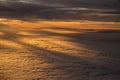 Sunset over Clouds with Mountain Tops from Plane Royalty Free Stock Photo