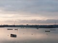 sunset over coast ocean bay water sky sea boats docks Royalty Free Stock Photo