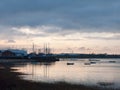 sunset over coast ocean bay water sky sea boats docks Royalty Free Stock Photo