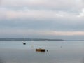 sunset over coast ocean bay water sky sea boats docks moored Royalty Free Stock Photo