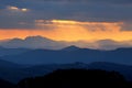 Sunset over color mountain silhouette. Royalty Free Stock Photo