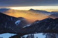 Sunset over color mountain silhouette with rays Royalty Free Stock Photo