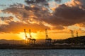 Sunset over the commercial port with cranes Royalty Free Stock Photo