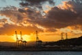 Sunset over the commercial port with cranes Royalty Free Stock Photo