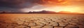 A sunset over a cracked desert somewhere on Earth, due to the lack of water and rising air temperatures caused by global Royalty Free Stock Photo