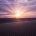 Sunset over desert dunes, with sunrays streaming through scattered clouds. The sky Royalty Free Stock Photo