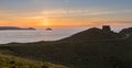 Sunset over Doyden Castle on coastline at Port Quin Royalty Free Stock Photo