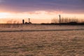 Sunset over farm field with hay bales. Concept of wildlife, fora Royalty Free Stock Photo