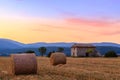 Sunset over farm field with hay bales near Sault Royalty Free Stock Photo