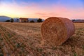 Sunset over farm field with hay bales near Sault Royalty Free Stock Photo