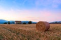 Sunset over farm field with hay bales near Sault Royalty Free Stock Photo