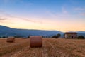 Sunset over farm field with hay bales near Sault Royalty Free Stock Photo