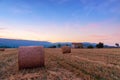 Sunset over farm field with hay bales near Sault Royalty Free Stock Photo