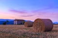 Sunset over farm field with hay bales near Sault Royalty Free Stock Photo