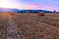 Sunset over farm field with hay bales near Sault Royalty Free Stock Photo