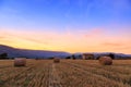 Sunset over farm field with hay bales near Sault Royalty Free Stock Photo