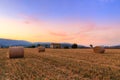 Sunset over farm field with hay bales near Sault Royalty Free Stock Photo