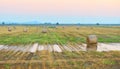 Sunset over farm field with hay bales Royalty Free Stock Photo