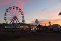 Sunset over Ferris Wheel and Carnival Rides