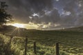 Sunset over field and dramatic sky in Lake District,Cumbria,Uk Royalty Free Stock Photo